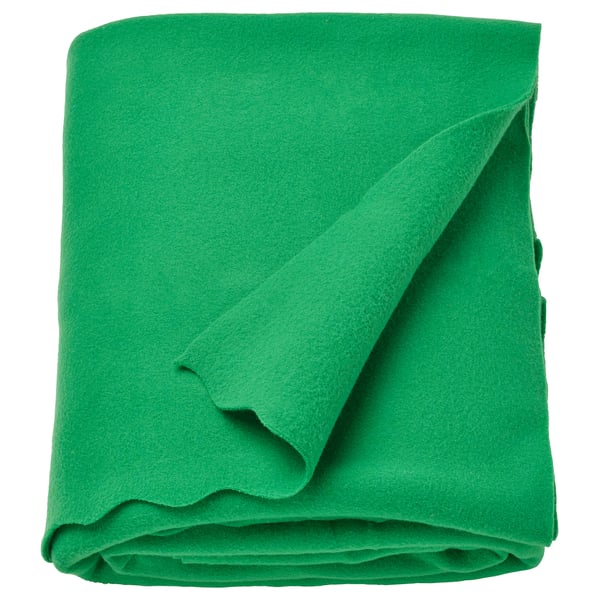 Green fleece blanket, soft and cosy, folded neatly. Made from 90% recycled polyester.
