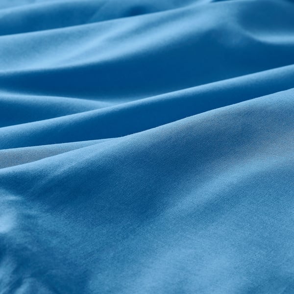 A close-up of smooth, crisp blue cotton fabric, showcasing its fine weave and high-quality texture.