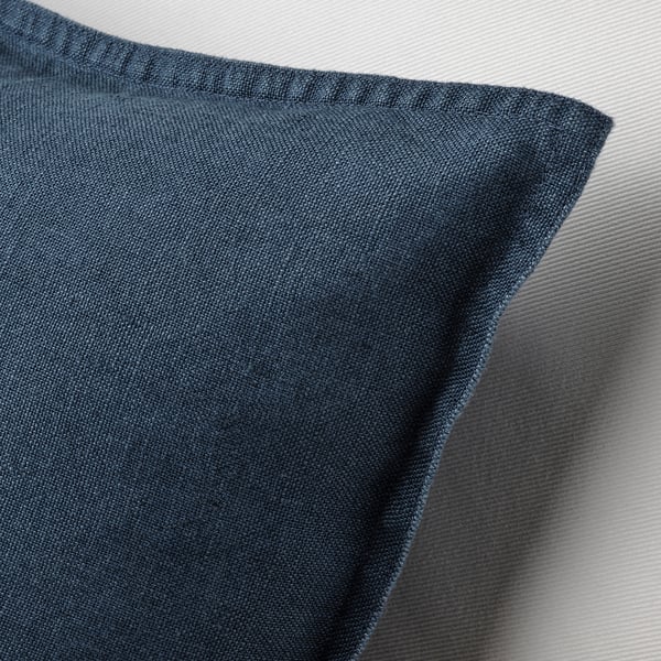 Close-up of dark blue linen cushion cover, showcasing its soft, textured fabric and hidden zip.