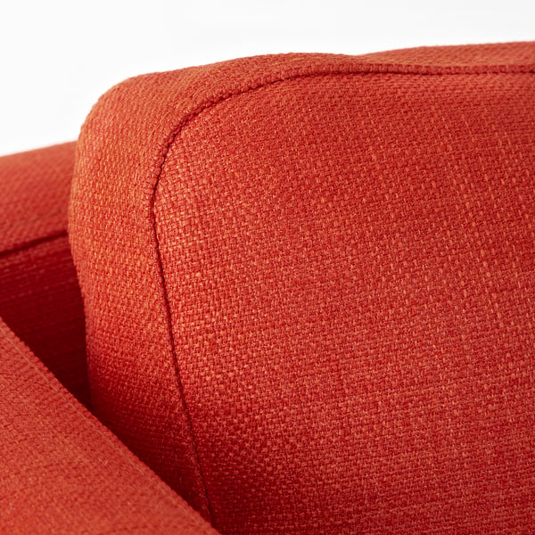 Close-up of an orange soft fabric chair, showcasing its sturdy stitching and plush texture.