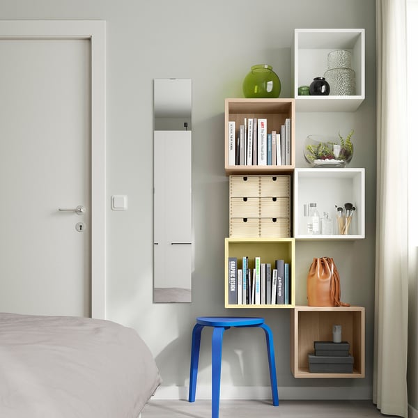 Modern bedroom with EKET shelves, colourful decor, and vibrant accents.