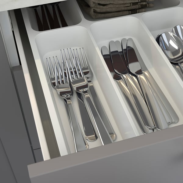 Kitchen drawer organiser with silverware: forks, knives, and spoons in compartments.