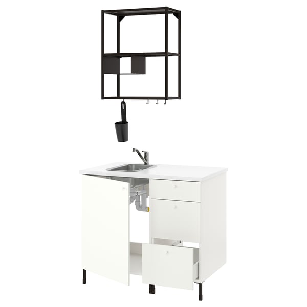 Modern white kitchen setup with stainless steel sink, black accessories, open shelves.