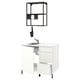 Modern white kitchen setup with stainless steel sink, black accessories, open shelves.