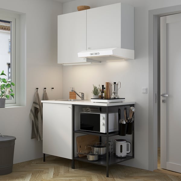 A modern ENHET kitchen with sink, microwave, open shelves, hood, and window.