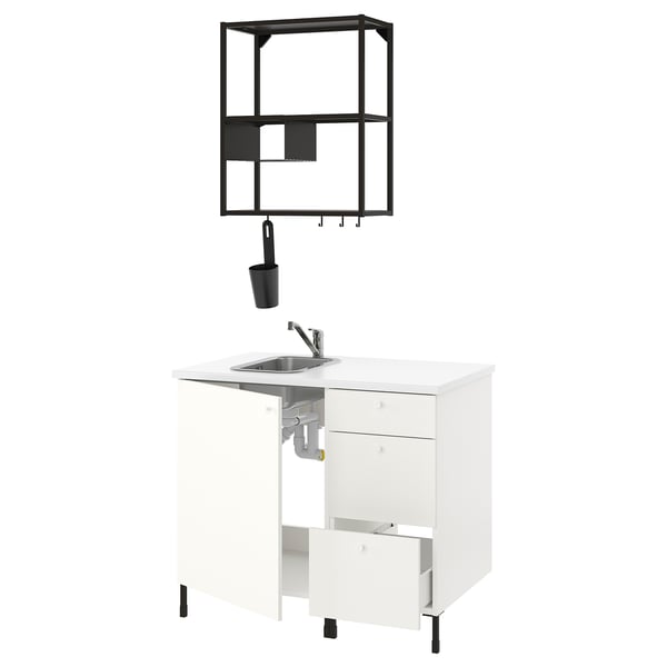 ENHET kitchen in white with black accents; modern, minimalist design featuring a sink, cabinet, and wall shelf.
