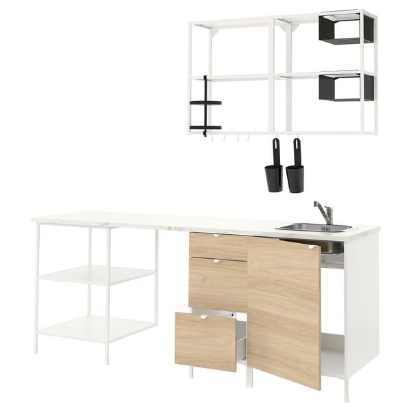 Modern minimalist kitchen setup with white and wood tones, featuring open shelving, cabinets, and stainless steel sink.