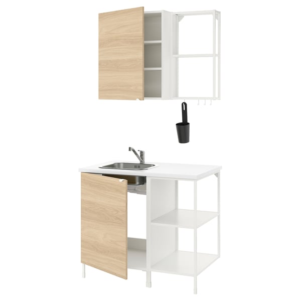 Modern kitchen setup: white & wood cabinet, sink, tap, hanging cup.