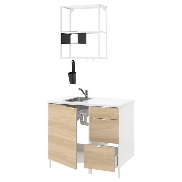 Modern white and wood kitchen unit with sink, tap, shelf, and black accessories.