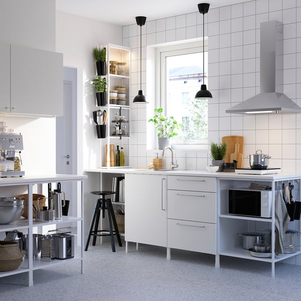 Modern white kitchen with ENHET series: base units with shelves, wall cabinets, countertop appliances, and hanging pendant lights.