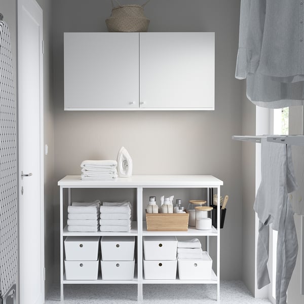 Modern laundry with ENHET cabinets. Iron, towels, and small items are organised.