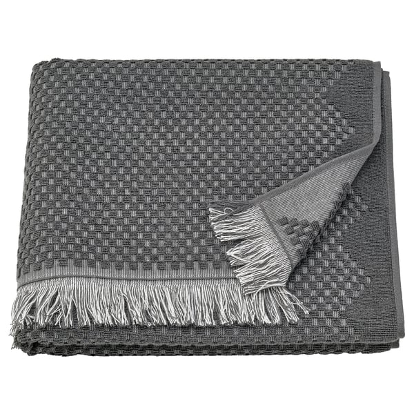 Dark grey, textured cotton towel with fringed edges; bohemian style.