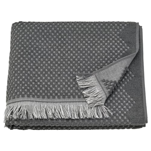 Dark grey, textured cotton towel with fringed edges; bohemian style.