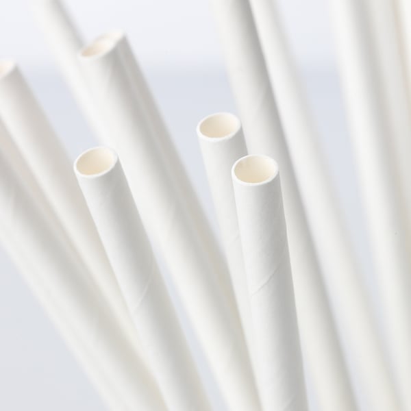 Four white paper straws arranged upright. High-quality, eco-friendly, and sturdy design.