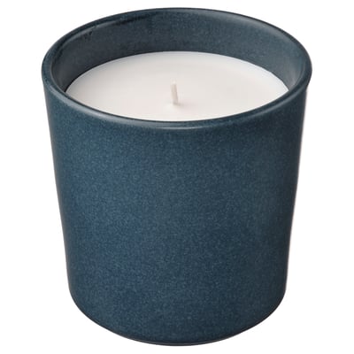 Blue ceramic candleholder with white candle, rustic, cosy decor.