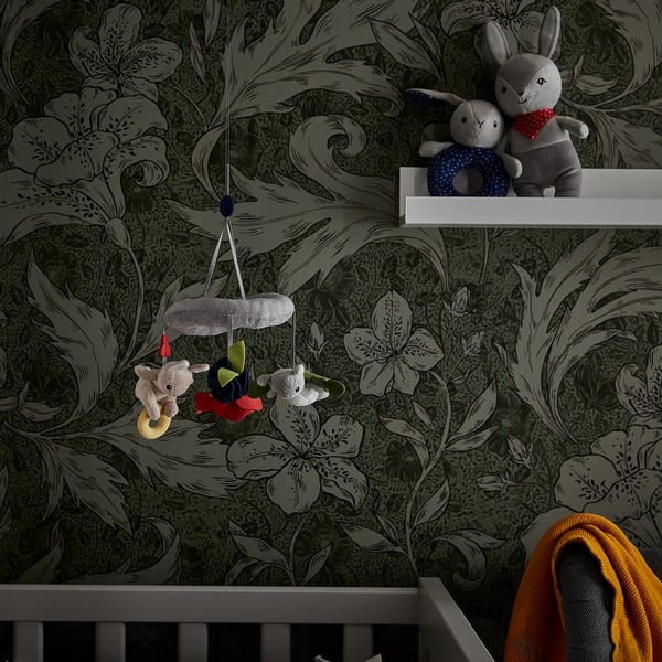 Nursery with floral wallpaper, mobile, bunnies, blanket