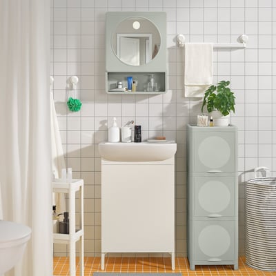 Bright green IVÖSJÖN cabinet in bathroom, maximising vertical storage with recycled polypropylene.