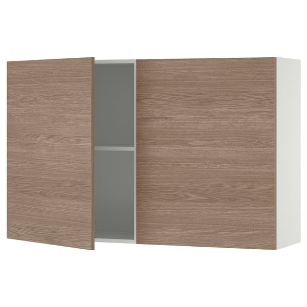 KNOXHULT wall cabinet in light brown wood. Two doors, one ajar revealing a grey interior and shelf. Modern and minimalist design.