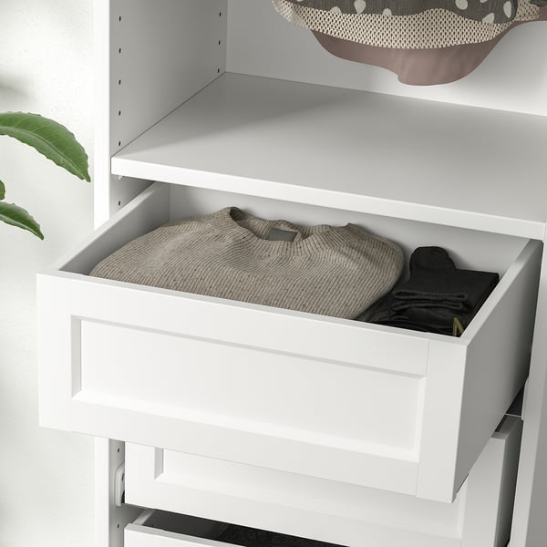 White wardrobe drawer with sweater and gloves, part of ikea KOMPLEMENT series, showcasing organized storage with soft-close mechanism.