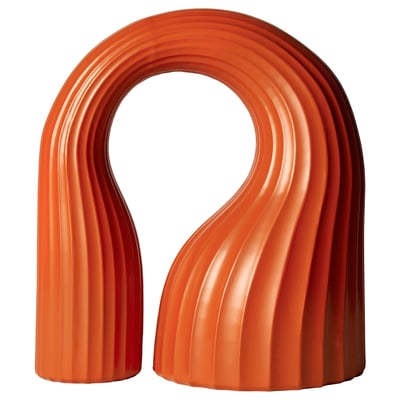 Bright orange, u-shaped KONSTRUNDA sculpture, ribbed design.