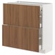 Modern white METOD kitchen cabinet with walnut-brown drawers, sleek design, smooth fronts, and metal drawer runners.