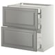 A white METOD kitchen cabinet with grey bodbyn drawers. It has a modern design with bevelled edges and two self-closing drawers.