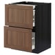 A METOD kitchen cabinet in walnut with wood grain texture and two drawers with silver handles and dividers.