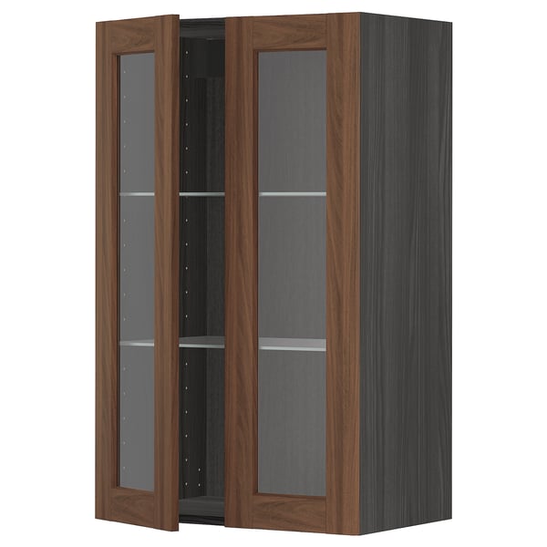 A dark wood-colored METOD kitchen cabinet with glass doors and shelves, offering a classic and stylish look.