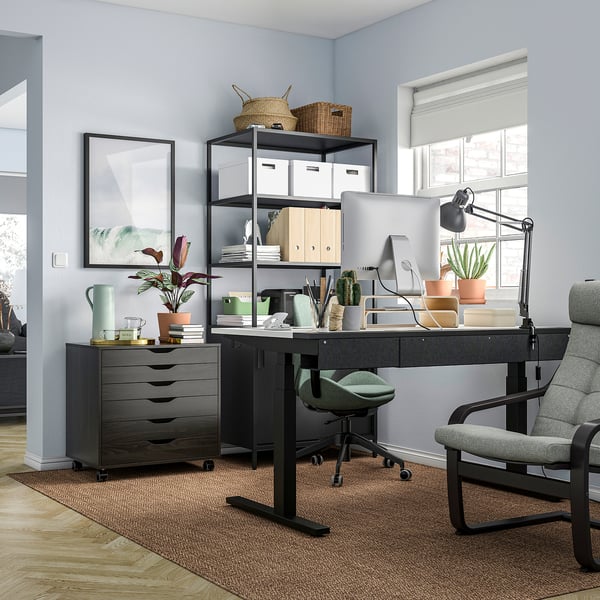 Modern home office with MITTZON black sit/stand desk, grey chair, and green accents.