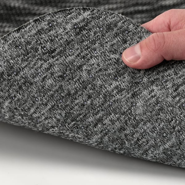 A hand pressing on a soft, textured seat pad designed for comfort and stability.