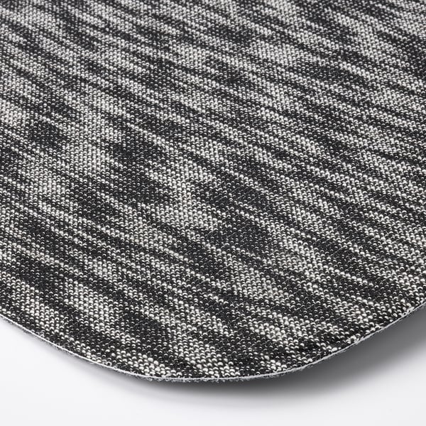 Close-up of round, textured seat pad with intricate black and white pattern. Superb detail and craftsmanship evident in fabric weave.