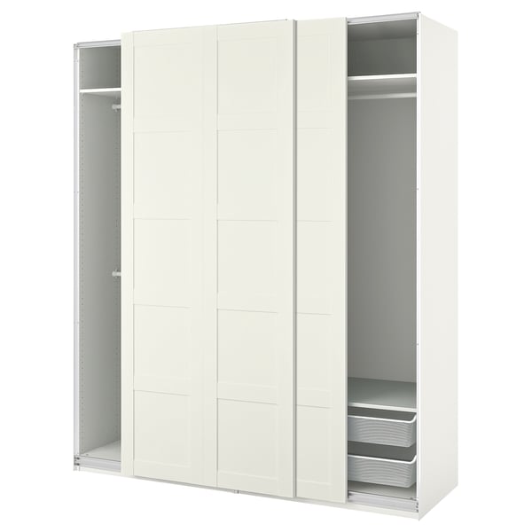 An ikea PAX white wardrobe with sliding doors and mesh drawers. The design is modern and minimalist.