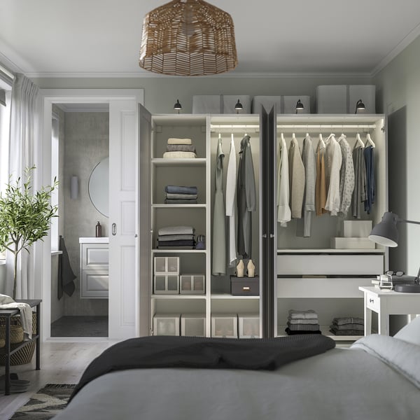 Modern bedroom with PAX wardrobe, clothes, lighting, partial bed, and en suite doorway.