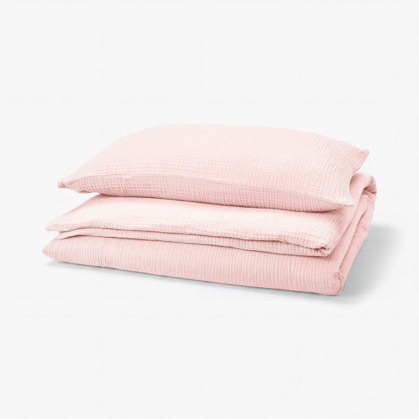 Folded pink SCHERSMIN duvet set of organic cotton, neatly stacked with textured surface and envelope/enclosure designs.
