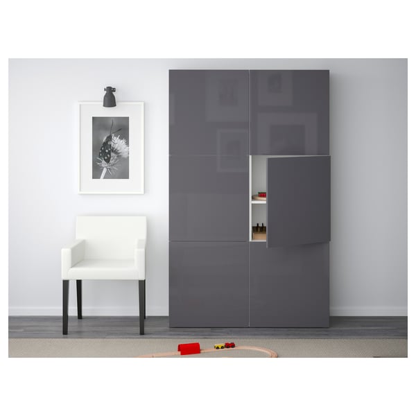 Modern room with grey SELSVIKEN cabinet, white chair, and black-and-white art. Toys on floor.