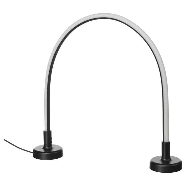 Two IKEA SMÅSNÖRE lamps in grey with black bases, featuring flexible necks and round designs, suitable for various rooms.