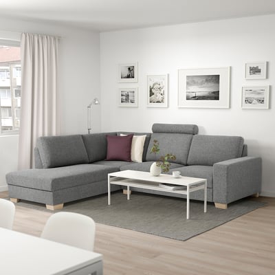 Modern living room: grey SÖRVALLEN l-shaped sofa, white coffee table, art wall, large window with light curtains.
