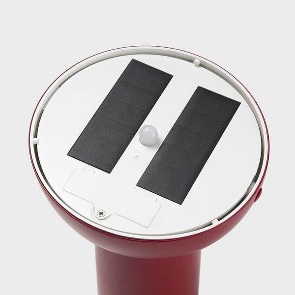 Red outdoor light with solar panels and a round base. Modern design, quality materials.