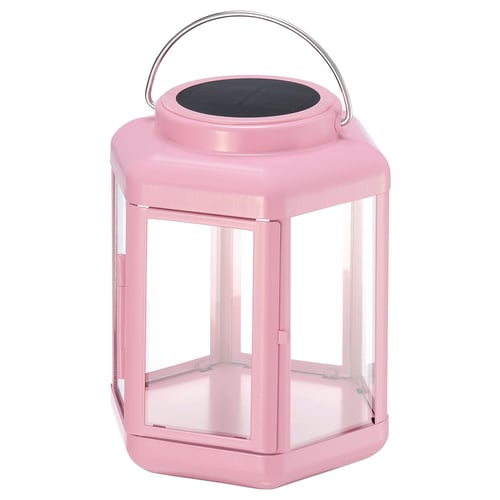 Pink solar-powered lantern with clear glass panels and metal handle. Modern design for indoor/outdoor use.