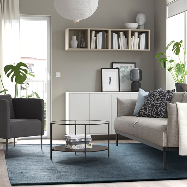 Modern living room with grey-blue TIDTABELL rug, adding warmth and comfort.