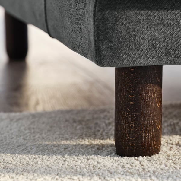 Modern sofa with dark wooden leg, grey fabric, quality craftsmanship.