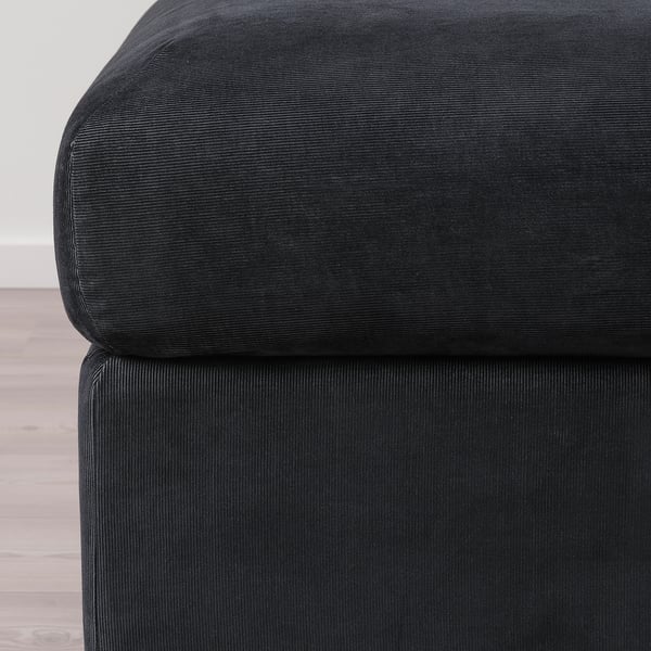 Black fabric sofa detail, showcasing soft, durable corduroy texture with clean lines and modern design.