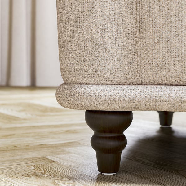 VISKAFORS beige sofa leg, curved design, wooden base, cosy room setting.