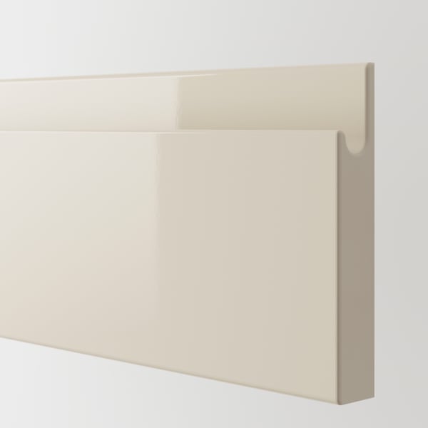 Modern cream-colored kitchen cabinet with high gloss finish, clean edges, and smooth surface, reflecting light beautifully.