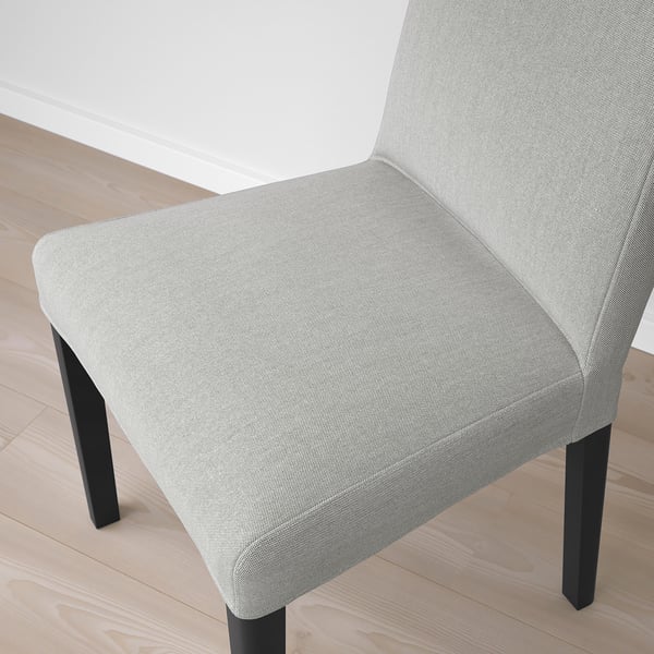 Modern upholstered chair with sleek design, comfort, and style. Light fabric, sturdy black legs.
