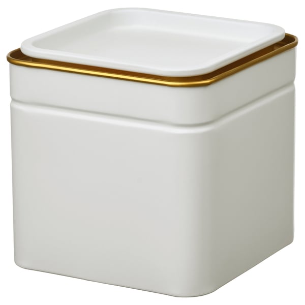 A bloming white square tin with a gold rim, sitting upright.