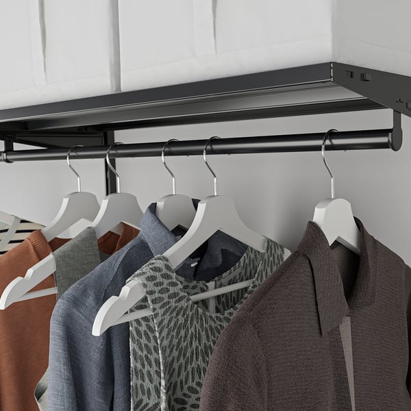 Closet with BOAXEL rail: hangs clothes neatly, organises by colour or style, mounts easily.