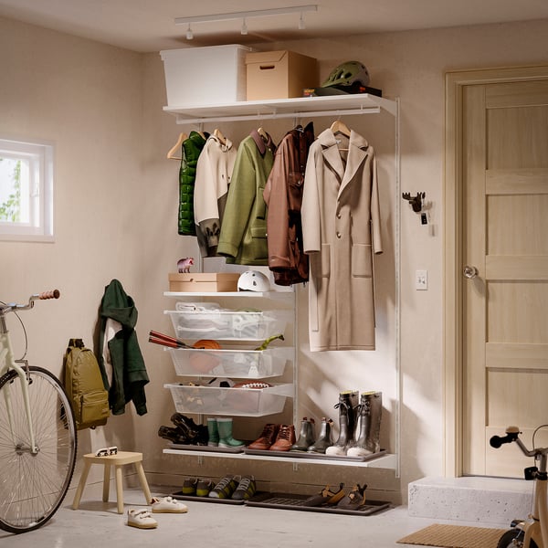 Beige BOAXEL entryway: coats, shoes, helmets, bike.