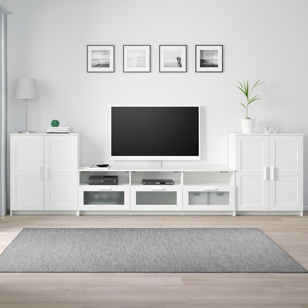 Modern living room with white BRIMNES tv stand, mounted tv, artwork, and decor.
