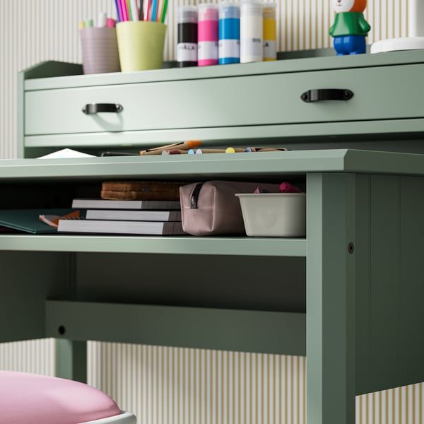 Small desk with open storage, perfect for study or crafts; includes shelves for organising items.